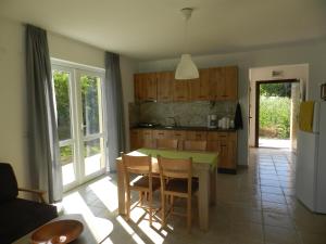 a kitchen with a table and chairs and a kitchen with a refrigerator at Villa Campo in Ezerets
