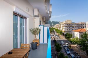 a balcony with a table and a view of a city at APT 48, COZY APARTMENT IN KALAMATA CITY CENTER in Kalamata