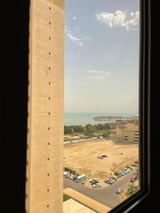 a view of a parking lot from a building at A journey of luxury Seaview living. in Kuwait