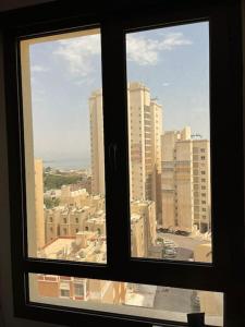 a view of a city from a window at A journey of luxury Seaview living. in Kuwait