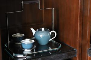 a tea pot and two cups on a shelf at The Ritz-Carlton, Haikou in Haikou
