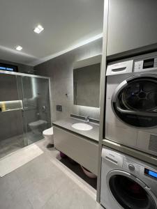 a bathroom with a washer and a washing machine at Z-Suites in Antalya