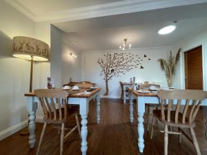 a dining room with a dining table and chairs at Bojangles Guest House in Gretna Green