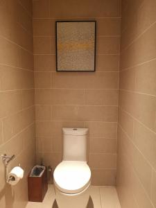 a bathroom with a toilet and a picture on the wall at Marriott Resort Xiangshui Bay in Lingshui