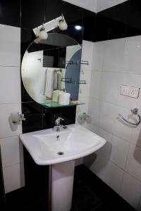 a bathroom with a white sink and a mirror at Villana Villa Bentota in Bentota