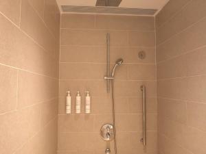 a bathroom with a shower with two bottles at Marriott Resort Xiangshui Bay in Lingshui