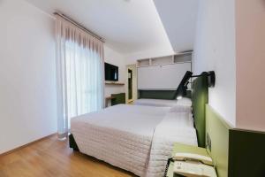 Postel nebo postele na pokoji v ubytování Hotel La Serena