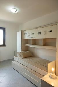 a bedroom with a large bed with shelves at Casa via materdomini in Brindisi