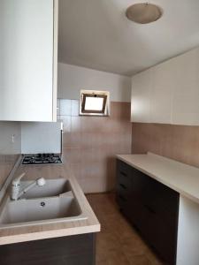 a kitchen with a sink and a stove at appartamento Alleria in Laterza