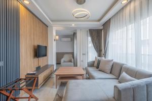 a living room with a couch and a table at Quality Gold Suite Hotel in Antalya