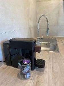 a kitchen counter with a sink and a mixer at Edles Apartment in Hanau mit Balkon und Freisitz, Pkw-Stellplatz in Hanau am Main