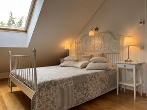 a bedroom with a bed with a white bedspread at Villa Sofia Boutique Trakai in Trakai