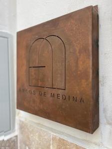 a metal box on a wall with the wordsacco be medicine at Arcos de Medina - Apartamentos premium in Córdoba