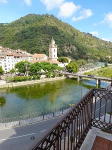 a bridge over a river with a mountain in the background at Bellavista in Dolceacqua