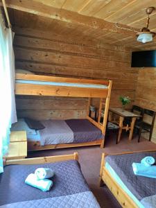 a bedroom with two bunk beds and a table at Willa Pod Jesionem in Poronin