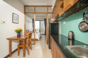 a kitchen with a table and a dining room at Carol Homestay & Apartment Đà Nẵng 4 in Da Nang