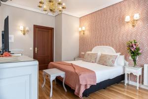 a hotel room with a bed and a tv at Hotel Infanta Isabel by Recordis Hotels in Segovia