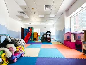 a childs play room with toys on the floor at HiGuests - Luxe Apartment With Incredible Marina Views in Dubai