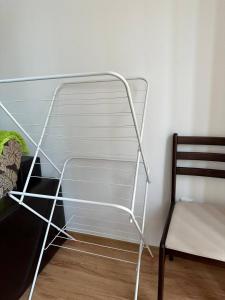 a metal shelf next to a chair in a room at Siana 4 Apartment (15) in Sveti Vlas