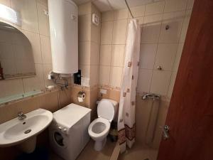 a bathroom with a white toilet and a sink at Siana 4 Apartment (15) in Sveti Vlas