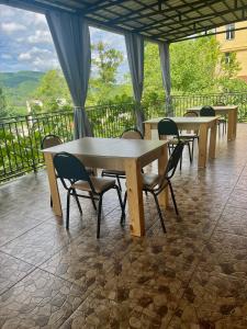 un grupo de mesas y sillas en un balcón en Elegance, en Signagi