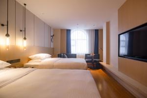 Ένα ή περισσότερα κρεβάτια σε δωμάτιο στο Fairfield by Marriott Harbin Downtown