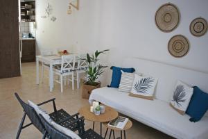 een woonkamer met een bank, stoelen en een tafel bij Fereniki's place in Gaios