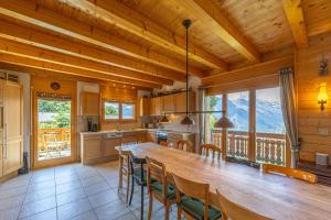 a kitchen with a large wooden table and chairs at Chalet Le Papillon - Calm, sunny, spacious in Nendaz