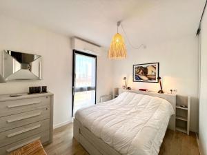 1 dormitorio con 1 cama, vestidor y ventana en T2 parking/climatisation - proche Halles au grain, en Toulouse