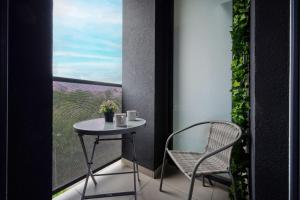 a small table and a chair on a balcony at Modern Studio with Balcony for 4 Guests in Wrocław by Renters in Wrocław