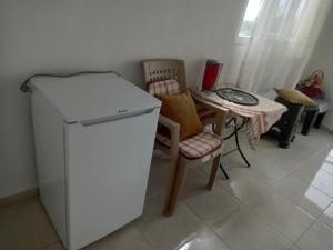 a kitchen with a small refrigerator and a table and chairs at Kır evi in Mugla