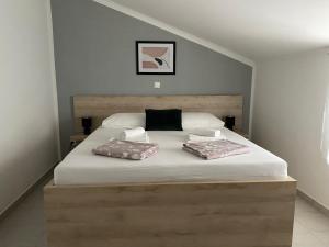 a bedroom with a bed with two pillows on it at Emanuela 1 in Novalja