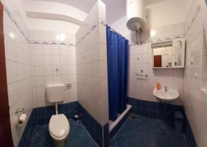 a bathroom with a toilet and a sink at Apartments Corny in Pag +10 photos