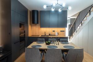 a kitchen with a dining room table and chairs at Apartmán Breeze in Stará Lesná