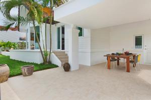 a patio with a table and a house at Villa Lawana - by Sublime Samui Villas in Bophut 