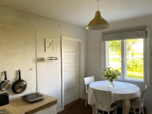 een keuken met een tafel met een witte tafeldoek bij Katrina Summer House in Jūrmalciems