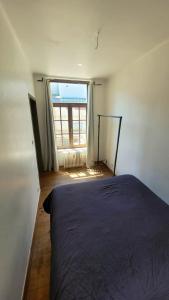 a bedroom with a bed and a large window at 2 bedrooms appartement with wifi at Bruxelles in Bons Villers