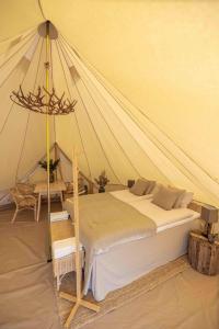 a bedroom with a bed in a tent at Camp Gielas, Arvidsjaur in Arvidsjaur