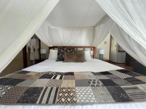 a bedroom with a large bed in a tent at Balingup Jalbrook Cottages Jalbrook Estate in Balingup