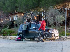 two people with bikes on the back of a truck at Kairos Valley Health & Nature Resort in Datca