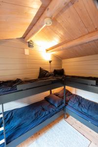 two bunk beds in a room with a ceiling at Cabin near the lake in Årset