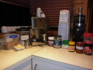 a kitchen counter with food ingredients on a counter top at A room 5 minutes' walk to the beach in Wellington