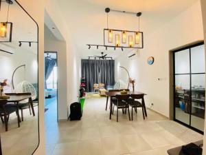 a dining room and living room with a table and chairs at Proboscis Guest House in Sandakan