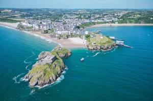 an aerial view of a small island in the ocean at Croft Court - 1 Bedroom Apartment - Tenby in Tenby