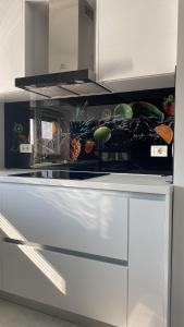 a kitchen with a counter with fruits and vegetables on it at Casa Andra in Dumbrăviţa