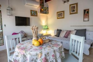 a living room with a table with fruit on it at Suite Kolibri in Galilee in Semadar