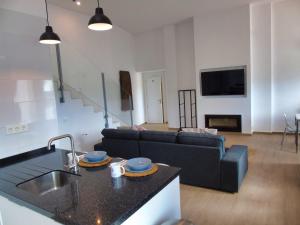 a kitchen and a living room with a couch at Villa Esperanza - Canillas de Albaida in Canillas de Albaida