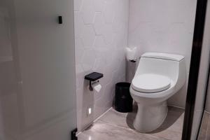 a bathroom with a white toilet and a trash can at Sheraton Zhaoqing Dinghu in Zhaoqing