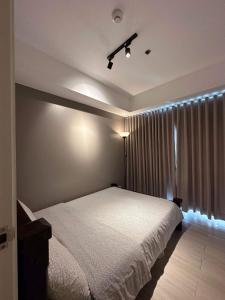a bedroom with a white bed and a window at AZURE URBAN RESORT RESIDENCE R&C - Parañaque in Manila