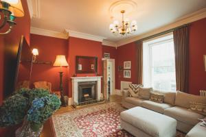 a living room with a couch and a fireplace at The Vean in Mevagissey